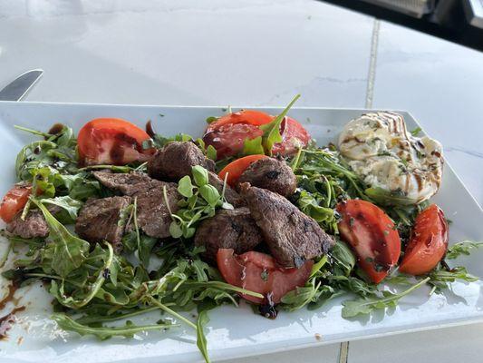 Perfectly seasoned and cooked steak tips with salad