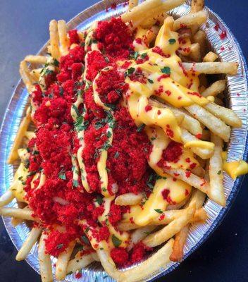 The XXTRA Flamin' Hot Cheetos Cheese Fries consist of fries topped with melted cheese and a delectable garnish of XXTRA Flamin' Hot Cheetos.