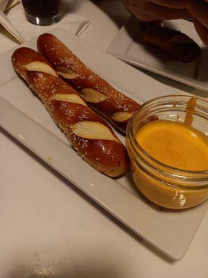 Half eaten order of pretzel sticks with beer cheese