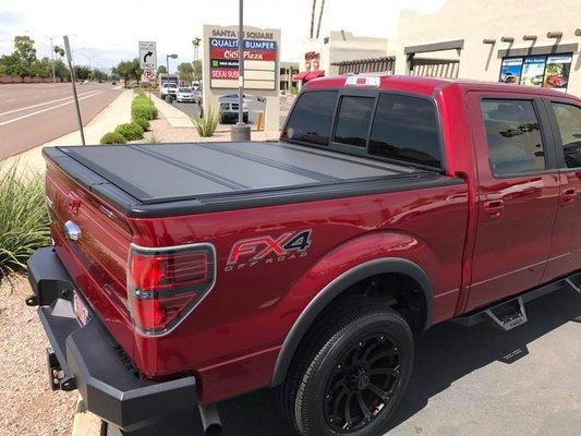 F-150 featuring the BakFlip MX4 Tonneau Cover. Also in this shot is the ICI Magnum Rear Bumper and ICI RT Series Steps.