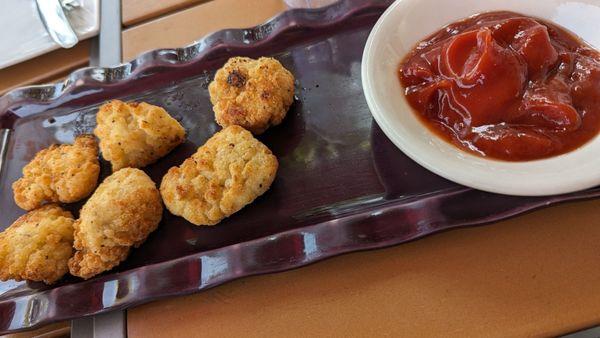 Chicken nuggets appetizer with a side of ketchup