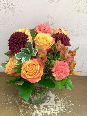 Orange and coral mixed flower arrangement