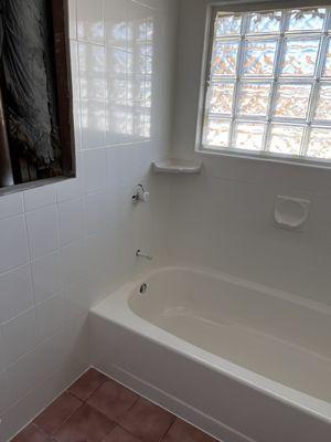 Bathtub and tile reglazed in Kohler White, with new corner shelf.