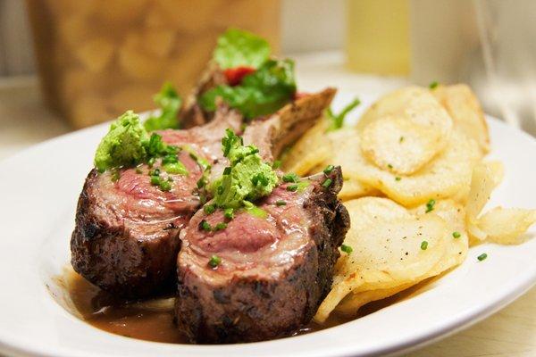 Roasted Rack Of Lamb with Provence Herbs and Olive Oil, Pommes LAndaises, red Wine Sauce and Garlic And Parsley Butter.