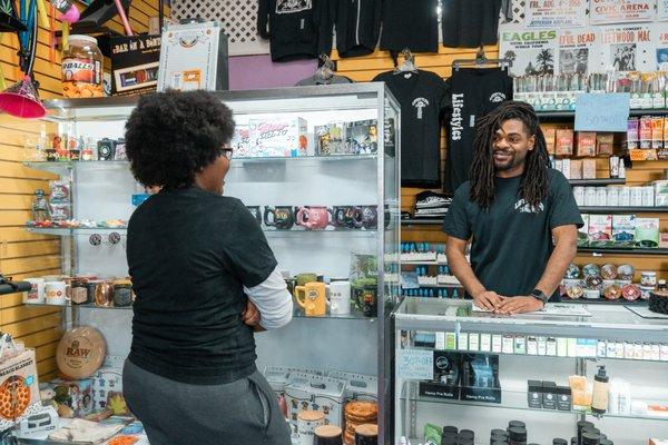 Lifestyles staff member smiling with a customer at the counter.