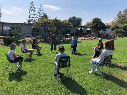 Upper Elementary students enjoying an outdoor lesson.