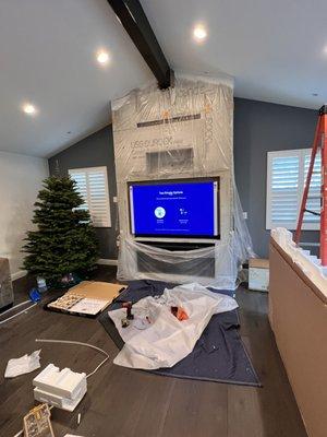 TV installation over fireplace on a full motion mount