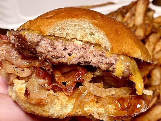 Cheddar Bacon Burger - 1/4lb beef patty, cheddar, applewood smoked bacon, grilled onions, bbq sauce on a potato bun + fries