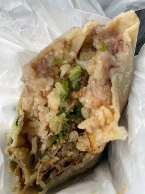 Inside carnitas burrito with everything rice, beans, onion, cilantro, salsa. So YUM!