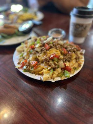 Steak fries topped with cheese, chorizo, and veggies