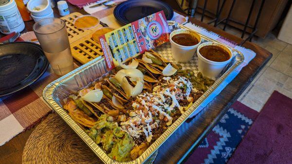 Birria pack with asada fries and consome.  Not shown but included was churros and soft serve dessert