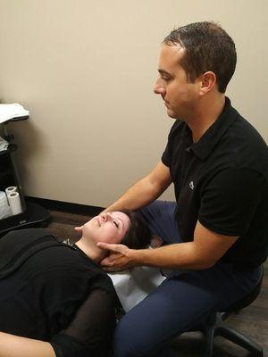 Dr. O'Connor adjusting a patient's cervical (neck) region.