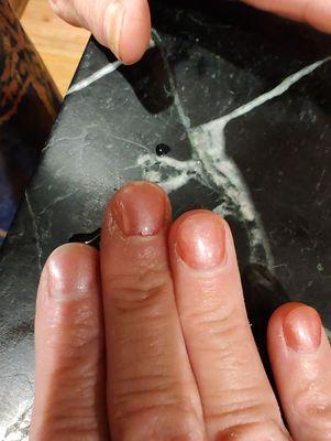 Chipped nails, with polish so thin you can see nail thru it.