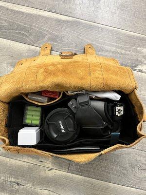 Camera Bag (Interior) Holding Nikon Camera plus two lenses and accessory items.