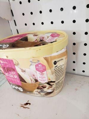 This ice cream package (and shelf) look like it has seen better days