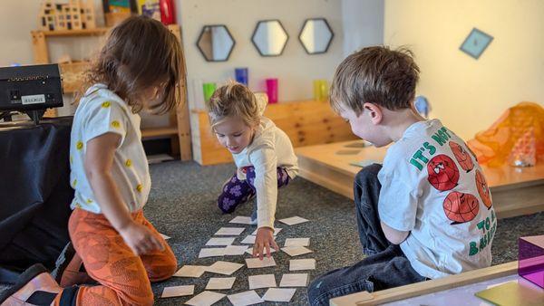 Preschool students play educational games during their small group time.