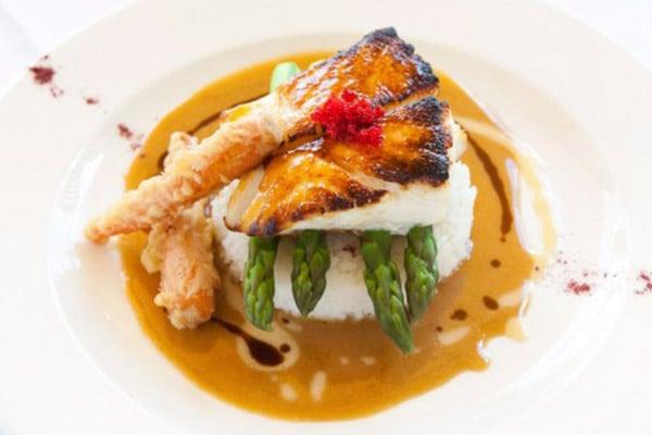 Nemo' signature dish: MISO BROILED SEA BASS
 citrus-ginger butter sauce, steamed rice or potato
 purée, asparagus , carrot tempura