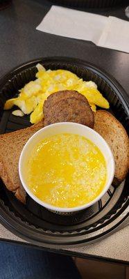 All Star Breakfast with Sausage, wheat toast, grits, two eggs, and a blueberry waffle.