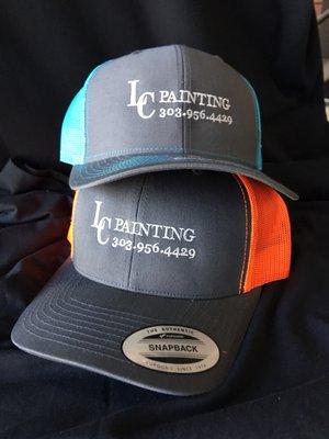 Assorted colors trucker hats with embroidered logo on front.