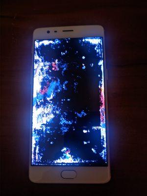 The phone after their repair. Screen was perfectly readable before, now almost completely purple/black.