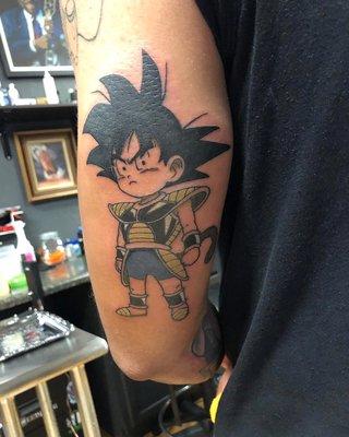 This tattoo was done by Armani at Blasted Ink. Goku in kid form.