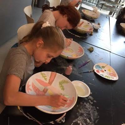 Greenwich Academy's focused artists work on their Parrot Pointillism Bowl during Summer Camp! Call and reserve your spot today.