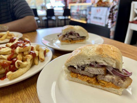 Salchipapa & PAN CON CHICHARRON / FRIED PORK WITH SWEET POTATOES TOPPED WITH A CRISP RED ONION RELISH ON A FRENCH ROLL.