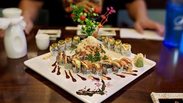 Front to back: Tiger Eye Roll, Crunchy Roll, Dancing Yellowtail, with a side of warm sake