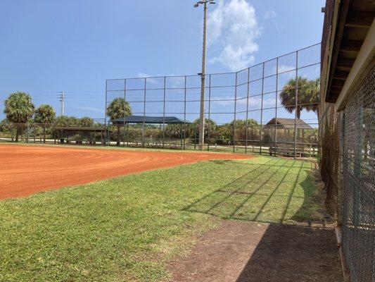 Great looking baseball field with dugouts, fenced in outfield and pitchers cage for batting practice