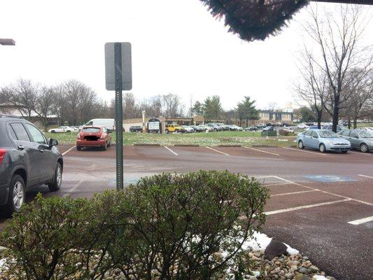 Empty dentist office parking lot. Orange car is mine.