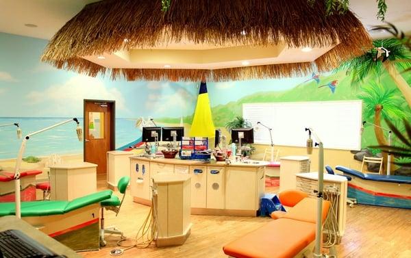 The open bay treatment area has a tropical backdrop, which creates a fun and playful atmosphere that puts children at ease.