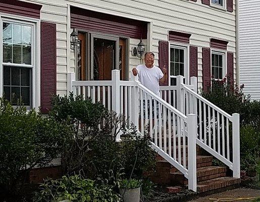 Client on his porch with his new railing, corrected and done to his satisfaction. His approval given with his "Thumbs Up" sign !!