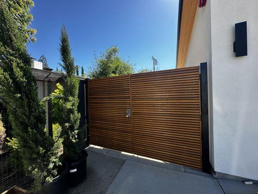 Modern Redwood Horizontal Entrance Gate. We do rolling gates, cantilever gates, single and double swing gates- you name it!