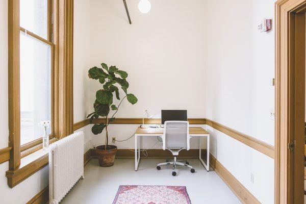 A small private office with natural light