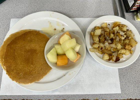 Pancakes, fruit, and home fries