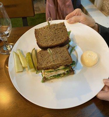 G&D Post-Workout Sandwich containing Black bread, Avocado, grilled chicken, torched tomato and arugula.