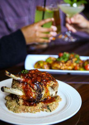 Pork Chop and Half Roasted Chicken with Guests Toasting in the background