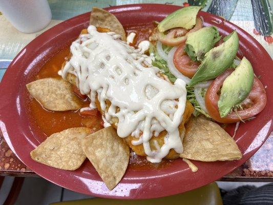 Shredded chicken burrito; included layers of chicken, Mexican rice, and refried beans inside a tortilla.