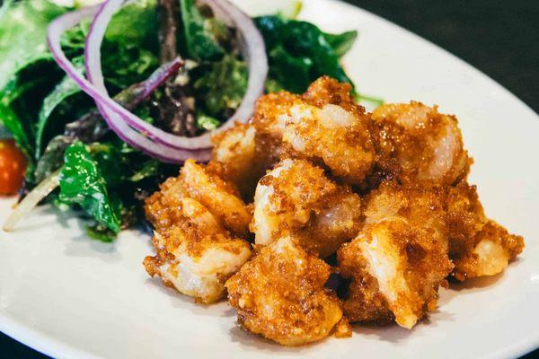 Boom Boom Shrimp! Made with breaded shrimp and tossed in our Thai chili glaze, this dish packs a flavorful punch & serve with organic Greens