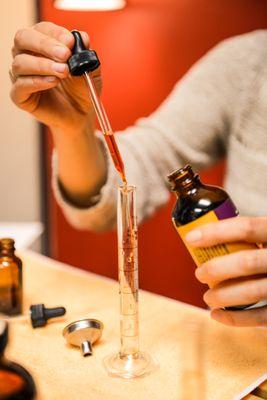 Preparing a custom herbal tincture.