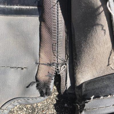 Passenger side of zipper, sewn shut