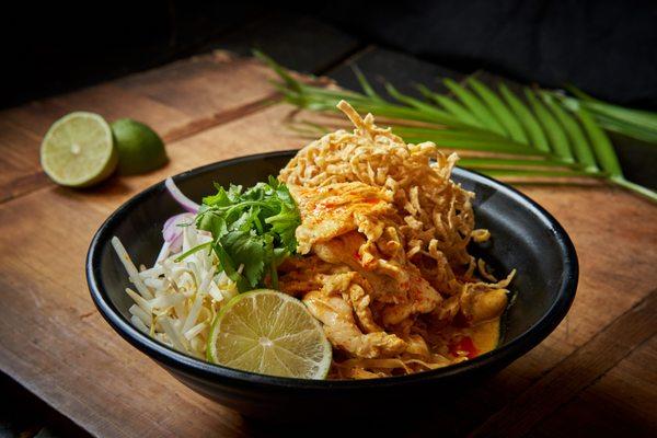 Chieng Mai Noodle Khow Soi Northern Style Chicken yellow curry, served with egg noodles topped with crispy egg noodles.