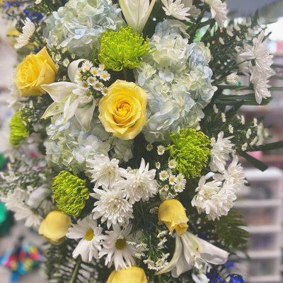 Beautiful hydrangeas, roses and lilies in a stunning standing spray.