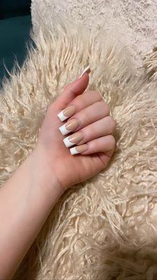 Acrylic nude nails with white tip gel.