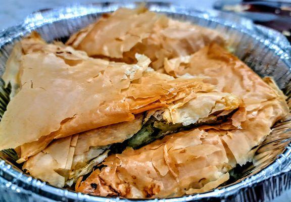 Spanakopites: spinach and feta cheese wrapped in flaky phyllo dough.