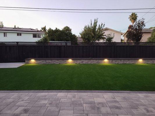 Outertainments created a garden retaining wall with lights and full irrigation system.