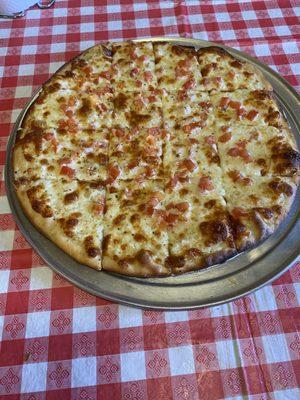 Pudgy's Butter pizza. We added tomatoes and onions on this one.