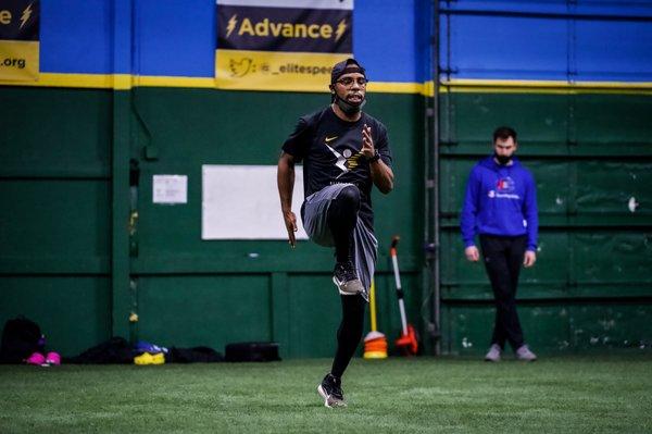 Coach James teaching proper sprinting technique.