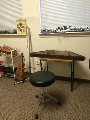 A psaltery and hammered dulcimer tuned up and awaiting the next student