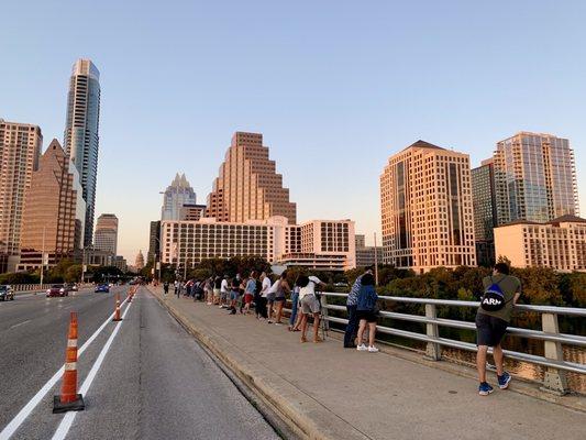 Visitors claiming their spots for views of the bats flying from underneath the bridge.